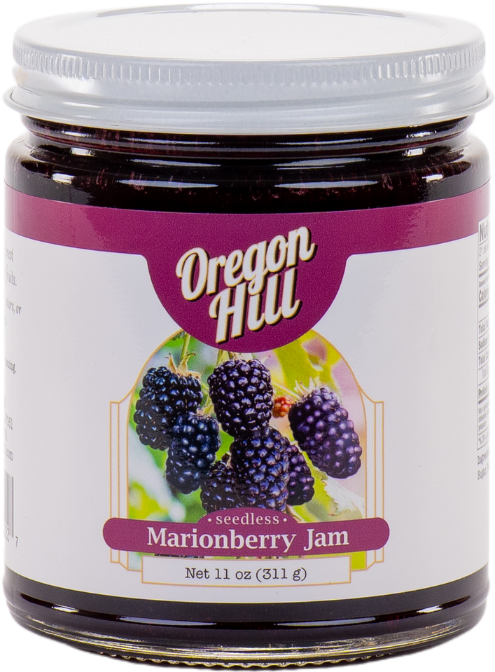 Jar of Oregon Hill seedless marionberry jam with a purple label and blackberries on it.